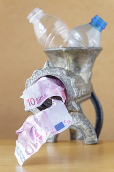 Plastic bottles in a meat grinder.Selective focus with shallow depth of field.
