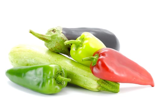 Green zucchini, eggplant and peppers on a white background.Selective focus with shallow depth of field.
