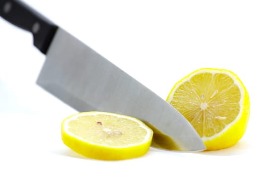 Cut with a knife yellow lemon on a white background.Selective focus with shallow depth of field.