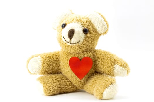 Teddy bear with red heart on white background