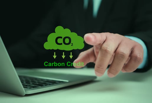 Carbon credit market concept. Businessman uses technology to exchange carbon credits, Carbon etf to invest in sustainable business, green climate funds investment, Net zero emission, Clean technology