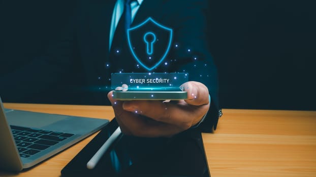 Cyber security technology concept, Businessman use phone and computer online showing protection icons cyber espionage, Represents the code protection, Security concept and communication technology.