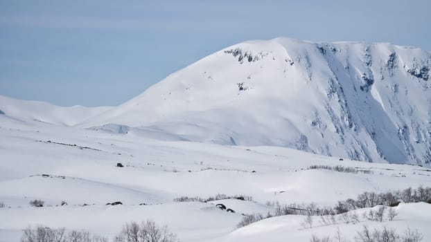 Norwegian high mountains in the snow. Mountains covered in snow. Scandinavian landscape in the far north