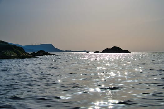 Norwegian fjord landscape. View of the open sea on the Western Cape. Crystal clear water, glistening in the sunshine. Landscape from Scandinavia
