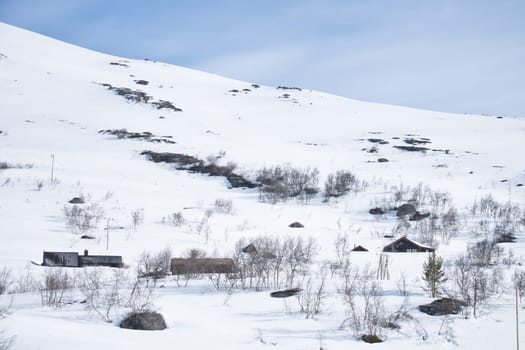 Norwegian high mountains in the snow. Mountains covered in snow. Scandinavian landscape in the far north
