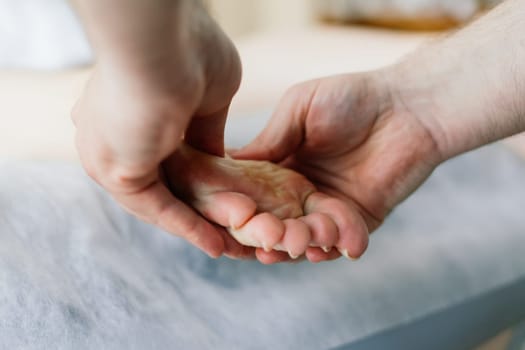 Anti-cellulite foot massage for fat woman. Concept of personal care, weight loss, diet. Close-up.