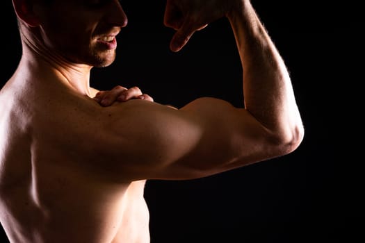 Portrait of man, bodybuilder and bicep flex in a studio, background and exercise for muscular power.