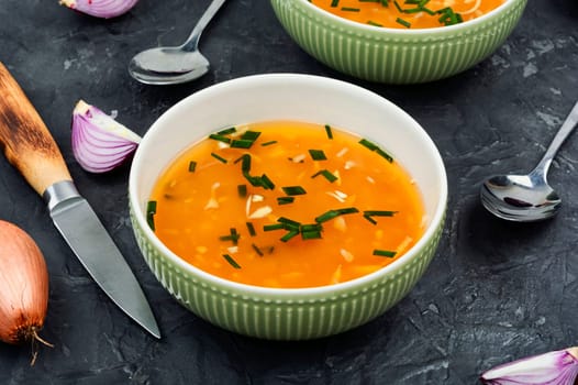 Tasty homemade onion soup in a ceramic bowl.