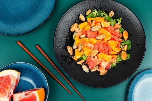 Spicy seafood salad with grapefruit, orange and mussels. Useful vegan dish. Flat lay