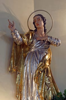 Saint John under the cross, statue on the main altar in the parish church Elevation of the Holy Cross in Kravarsko Croatia