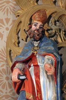 Saint Ambrose, statue on the main altar in the parish church of Saint John the Baptist in Gornji Desinec, Croatia