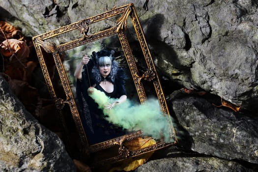 An evil witch works her magic in a mysterious enchanted mirror