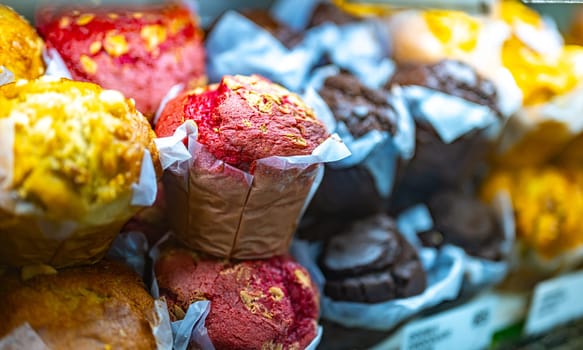 Different types of muffins for sale in a bakery.
