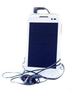 Cellular phone with headphones on white background