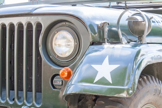 Details of the radiator grille and headlights of a military vintage car