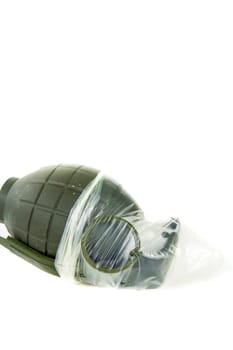 Condoms placed on a hand grenade on a white background