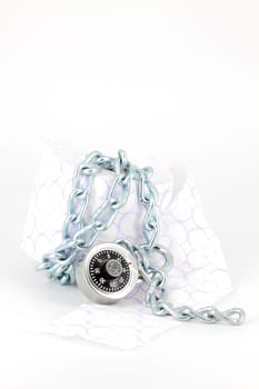 Roll toilet paper locked with padlock and chain on white background