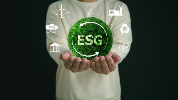 A Man holding globe with ESG icon green earth concept for environment Society and Governance sustainable environmental concept of the world, Green business natural environment, Save earth.