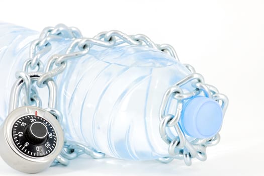 Bottle of mineral water locked with chain and padlock on white background