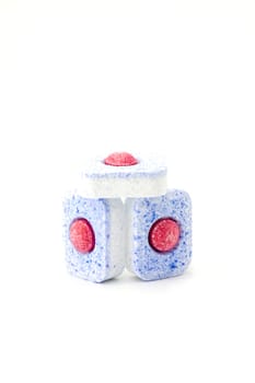 Group of three dishwasher tablets on a white background