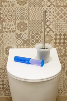 Modern toilet bowl with blue detergent for cleaning and disinfection