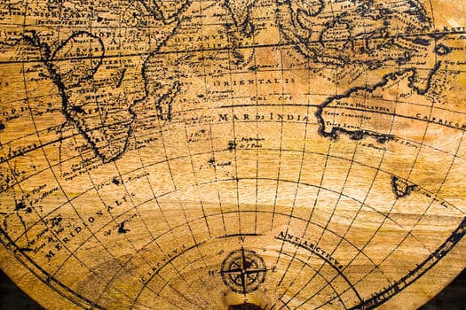Old Geographic map of the world printed on a wooden board