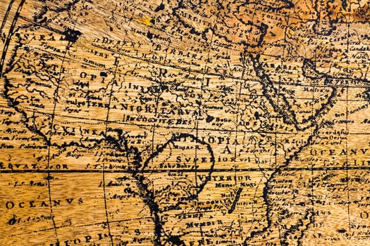 Old Geographic map of the world printed on a wooden board