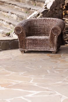 Old braided wicker chair with signs of wear