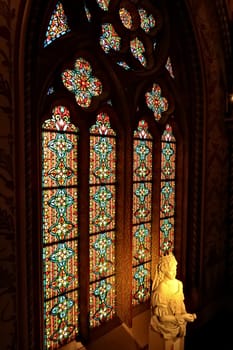 Bust, statue of Empress Elisabeth of Austria, Sissi, Sisi in front of a colorful stained glass window in a gothic shape inside the Matthias Church, Budapest, Hungary 2022