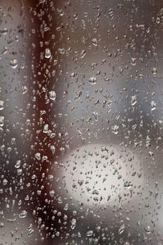 Raindrops on the surface of the dusty window