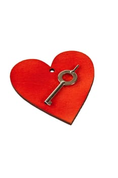 Red wooden heart on which stands a metal key