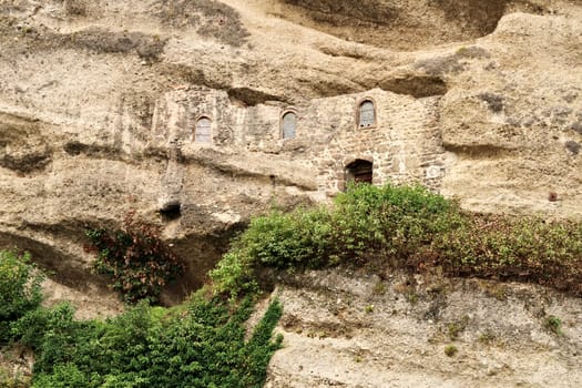 View onto the facade of the hidden Maximus Chapel, Cave, Maximuskapelle, Maximushöhle, built into a cave in a cliff of the Mönchsberg, part of the Catacombs of Salzburg at the St. Peter*s Cemetery, Salzburg, Austria 2022