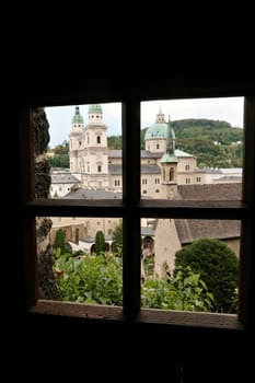 View onto the St. Peter's Cemetery from a window inside the Maximus Chapel, Cave, Maximuskapelle, Maximushöhle built into a cave in a cliff of the Mönchsberg, part of the Catacombs of Salzburg at the St. Peters Cemetery, Salzburg, Austria 2022
