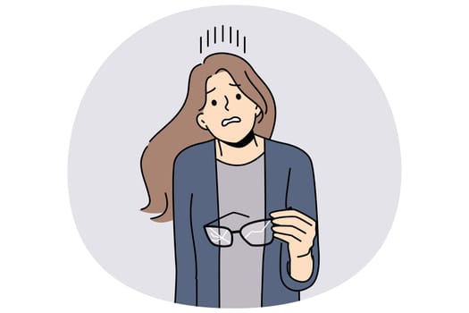 Woman with broken glasses in hands makes confused face not knowing how to solve vision problem. Careless girl holds glasses with cracked glass and needs to go to optometrist or buy contact lenses