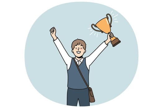 Schoolboy with golden cup rejoices at award received for winning school mathematics olympiad. Schoolboy with trophy makes winning gesture demonstrating leadership qualities while receiving education