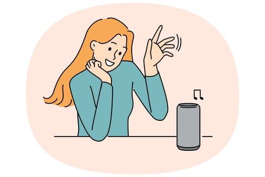 Woman uses wireless speaker with voice control to listen to music or communicate with virtual interlocutor. Wireless speaker for smart home and IOT technology near young smiling girl