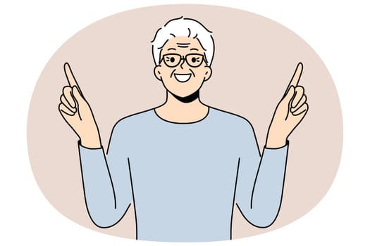 Eldery man came up with idea and points fingers up with smile to draw attention to your ad. Gray-haired pensioner in glasses recommends paying attention to good offer or cool idea.