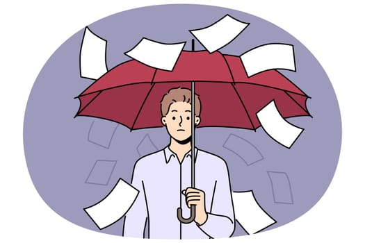 Businessman suffering from bureaucracy standing with umbrella among falling documents symbolizing overabundance of paperwork. Business concept of inefficiency in corporation due to bureaucracy