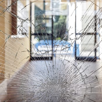 Shattered glass. Concept security theft damage vandalism in an apartment building.