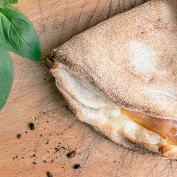 Closed pizza. Pinsa romana and scrocchiarella gourmet italian cuisine. Traditional dish in italy.