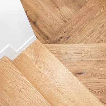 Wood staircase inside contemporary white modern house. Modern residential wooden stairs.