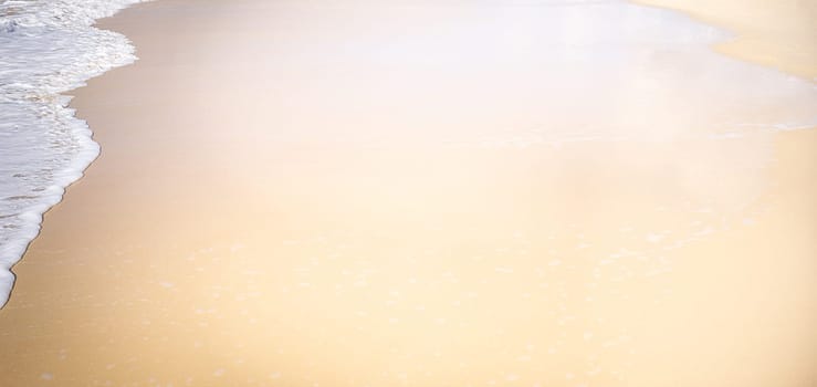 A conceptual sandy beach background with lots of copy space, neutral space for text and AI editing, nobody, no landmarks, just wet sand and white foamy water