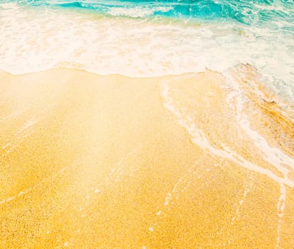 Tropical sandy beach and sea wave from above. Sand and water on tropical island top view. Exotic island summer holiday vacation background. Travel destination banner design.