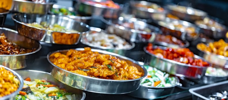 Traditional Asian dishes sold in a shopping mall food court in Singapore.
