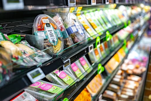 SINGAPORE - MAY 11, 2024: Variety of food products put up for sale in a commercial refrigerator