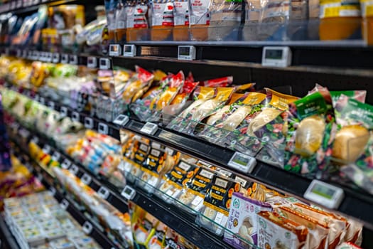 SINGAPORE - MAY 11, 2024: Variety of food products put up for sale in a commercial refrigerator