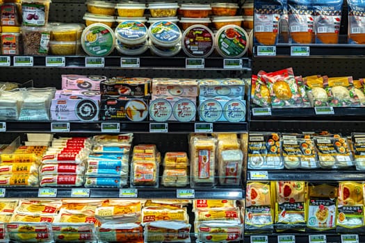 SINGAPORE - MAY 11, 2024: Variety of food products put up for sale in a commercial refrigerator