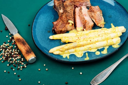 Barbecue meat steak with white asparagus.