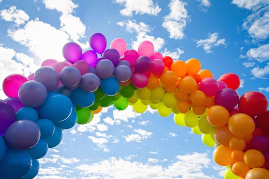 Colorful balloons arranged in the shape of a rainbow, symbolizing hope and positivity