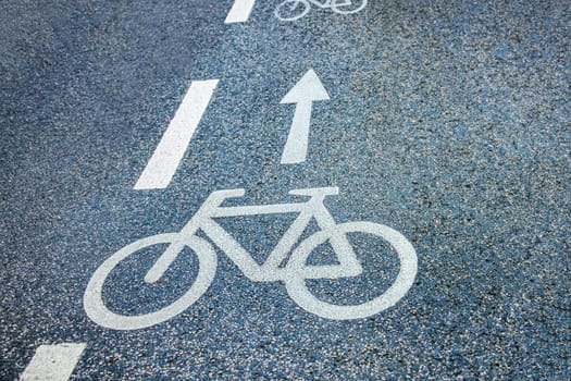 Bicycle, stripes and arrow symbols on the street.